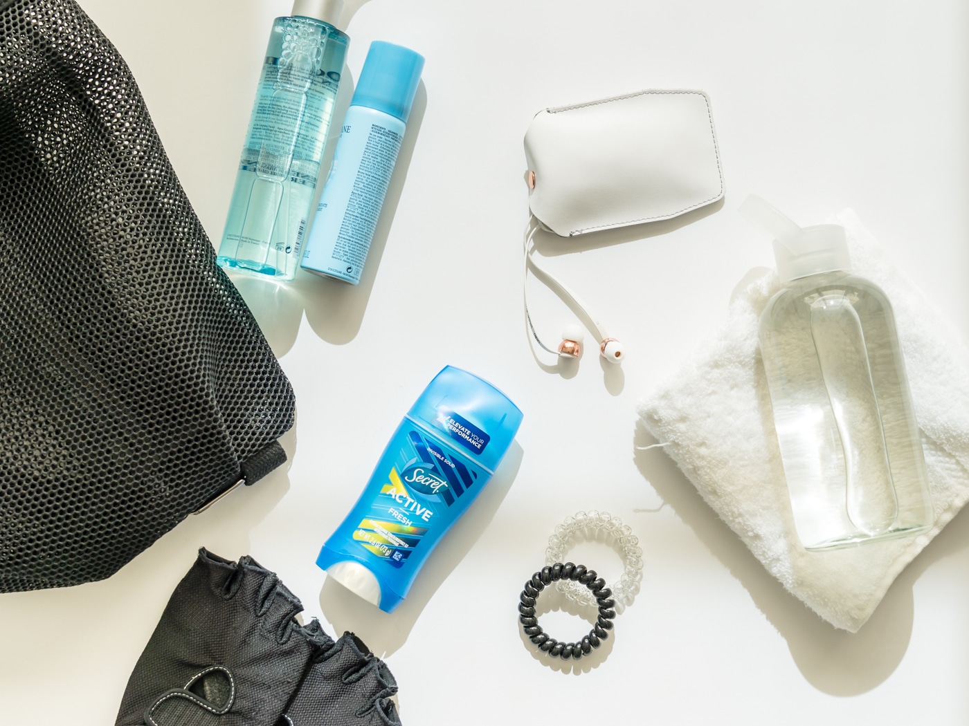 Gym essentials: gloves, earphones, deodorant, water bottle, gym bag
